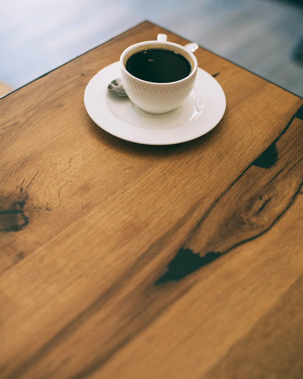 Sample photo: black coffee in a plain cup on a wooden table
