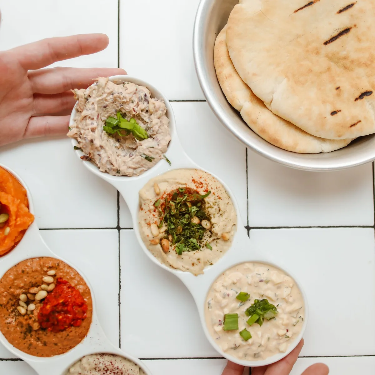 Sample photo: pita bread and dips on white tiles